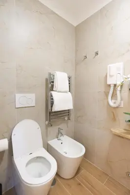 a bathroom with a white toilet and a sink at B&B Smart Rooms in Rome