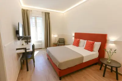 a bedroom with a bed and a desk with a computer at B&B Smart Rooms in Rome