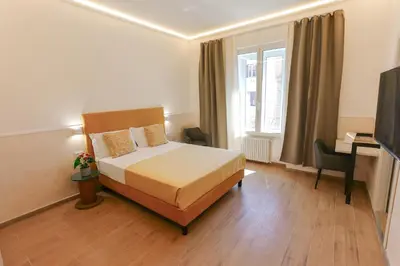 a bedroom with a bed and a desk and a television at B&B Smart Rooms in Rome
