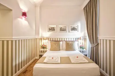 a hotel room with a bed with towels on it at La Maison di Sant'Anna in Rome