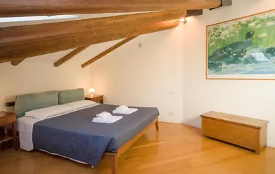 a bedroom with a bed and a painting on the wall at Appartamento a Castel Sant'Angelo con terrazza in Rome
