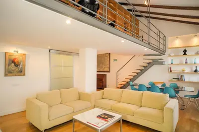 a living room with a couch and a staircase at Appartamento a Castel Sant'Angelo con terrazza in Rome