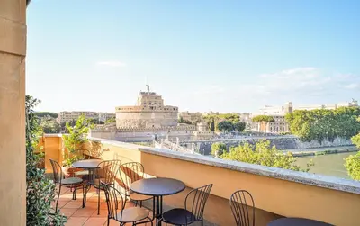a balcony with tables and chairs and a view of the city at Appartamento a Castel Sant'Angelo con terrazza in Rome