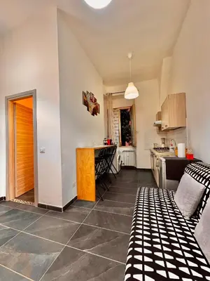 a kitchen with a table and a counter in a room at AMP Vatican House in Rome