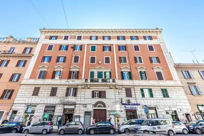 a large building with cars parked in front of it at AMP Vatican House in Rome
