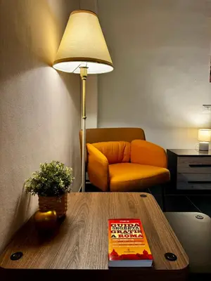 a room with a table with a lamp and a couch at AMP Vatican House in Rome