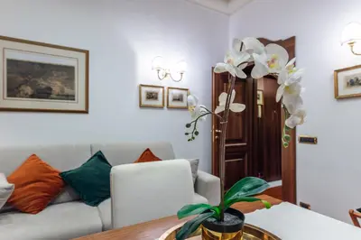 a lamp on a table with a green wall at Pantheon Antique Suite in Rome