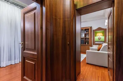 a kitchen with wooden walls and a wooden door at Pantheon Antique Suite in Rome