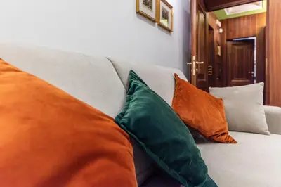 a living room with a table and a couch at Pantheon Antique Suite in Rome