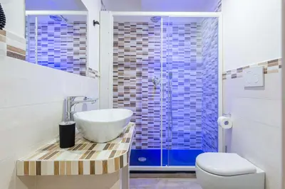 a bathroom with a sink and a toilet and a shower at chèri luxury suite in Rome