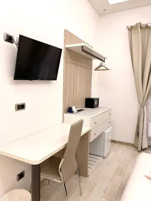a room with a desk and a tv on a wall at Rose Suite in Rome