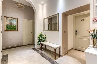 a hallway with a bench and a mirror at Rose Suite in Rome