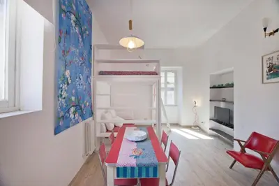 a room with a bunk bed with a table and chairs at Colosseum relax family apartament in Rome