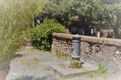 a stone wall with a pole in front of it at Colosseum relax family apartament in Rome