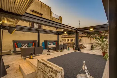 an outdoor patio with couches and chairs on a building at Casa Argileto in Rome