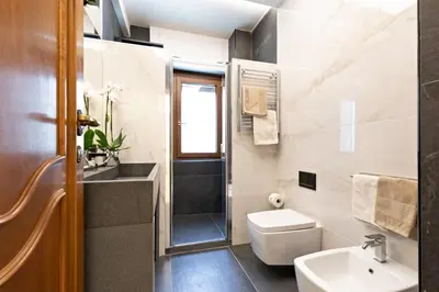 a bathroom with a toilet sink and a shower at First Class Rome Apartments in Rome
