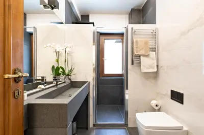 a bathroom with a sink and a toilet and a shower at First Class Rome Apartments in Rome