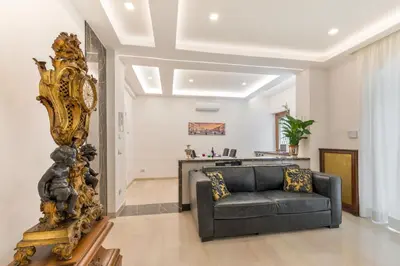 a living room with a couch and a mirror at First Class Rome Apartments in Rome