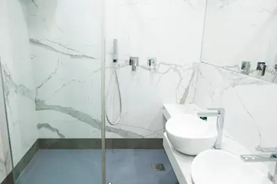 a bathroom with a shower and a toilet and a sink at Hadrianus Temple Suites - The Venue Collection in Rome