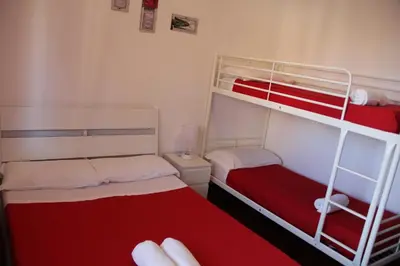 two bunk beds in a room with red and white at Domus Vatican Holiday's in Rome