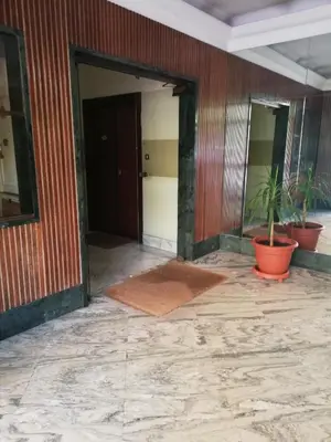 an empty room with two potted plants in a building at Domus Vatican Holiday's in Rome