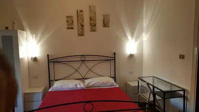 a bedroom with a bed with a red blanket at Domus Vatican Holiday's in Rome