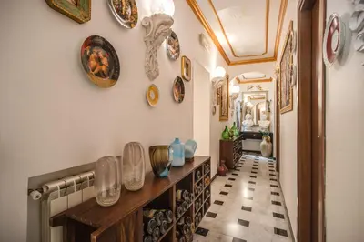 a hallway with plates and vases on the wall at Nakissa Inn in Rome