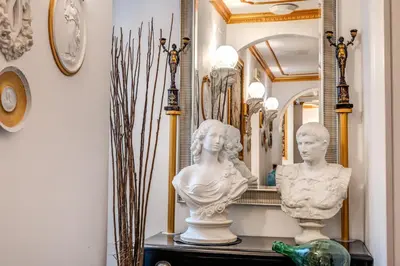 a room with statues on a table in front of a mirror at Nakissa Inn in Rome