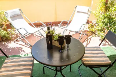 a table with two wine bottles and two chairs at InternoUno Deluxe in Rome