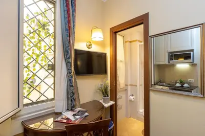 a small room with a table and a window at InternoUno Deluxe in Rome