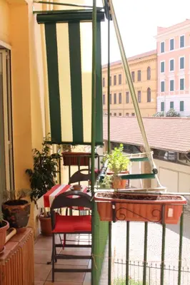 a balcony with a chair and a table with plants at Hazelrome apartment in Rome