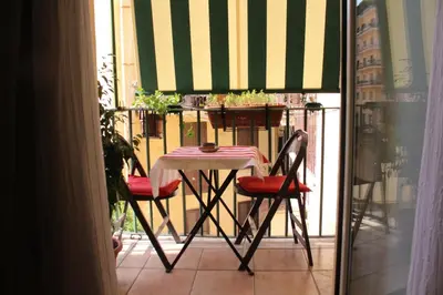 a table and two chairs on a balcony at Hazelrome apartment in Rome
