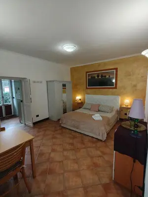 a bedroom with a bed and a table in it at Piramide Gold in Rome