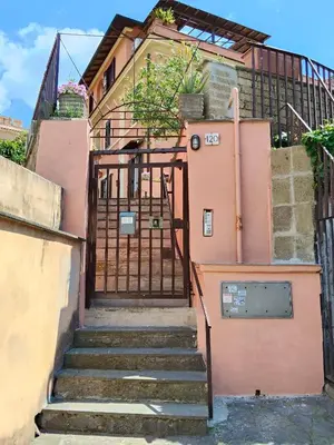 a set of stairs leading up to a pink building at Piramide Gold in Rome
