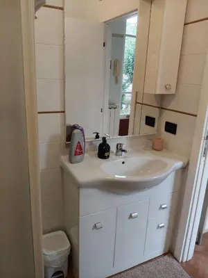 a bathroom with a white sink and a mirror at Piramide Gold in Rome