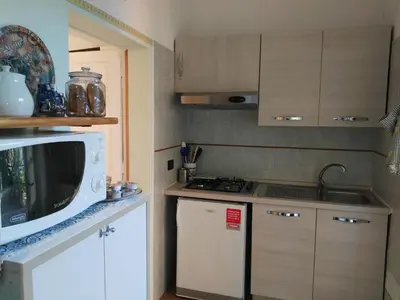 a small kitchen with a microwave and a sink at Piramide Gold in Rome