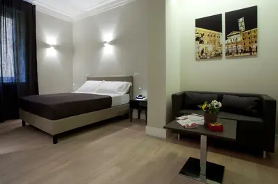 a hotel room with a bed and a couch at Regola Suite in Rome