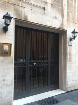 a black door on a building with two lights at Regola Suite in Rome