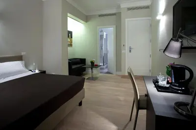 a bedroom with a bed and a dining room with a table at Regola Suite in Rome