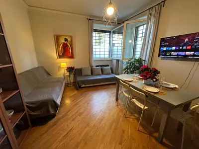 a living room with a couch and a table at Domus Giulio Cesare Apartment in Rome