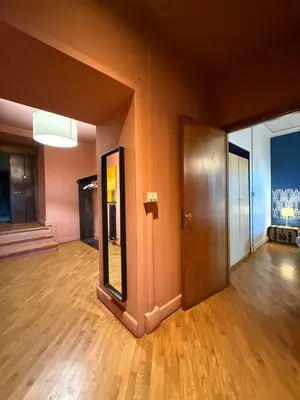 an empty room with a door and a mirror at Domus Giulio Cesare Apartment in Rome