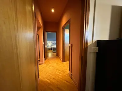 a hallway with an open door to a room at Domus Giulio Cesare Apartment in Rome