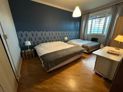a bedroom with two beds and a table and a lamp at Domus Giulio Cesare Apartment in Rome