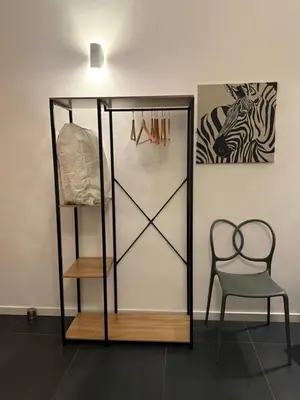 a room with a shelf and a chair and a picture at Claudio My House in Rome