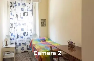 a bedroom with a bed and a window with a curtain at Easylife in Rome