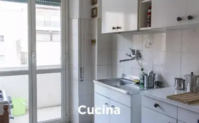 a white kitchen with a sink and a window at Easylife in Rome
