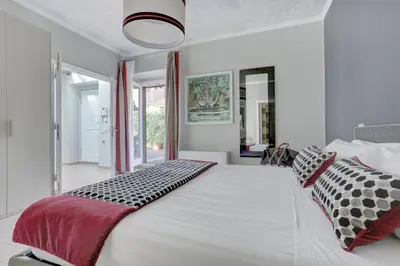 a bedroom with a large bed with black and white pillows at Piazzetta Margutta - My Extra Home in Rome