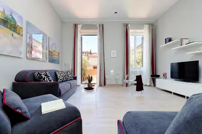 a living room with two couches and a tv at Piazzetta Margutta - My Extra Home in Rome