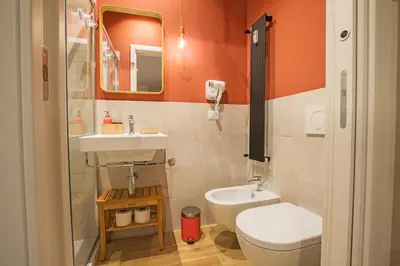a small bathroom with a toilet and a sink at Ziani Vatican Boutique in Rome