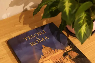 a book on top of a table with a plant at Ziani Vatican Boutique in Rome